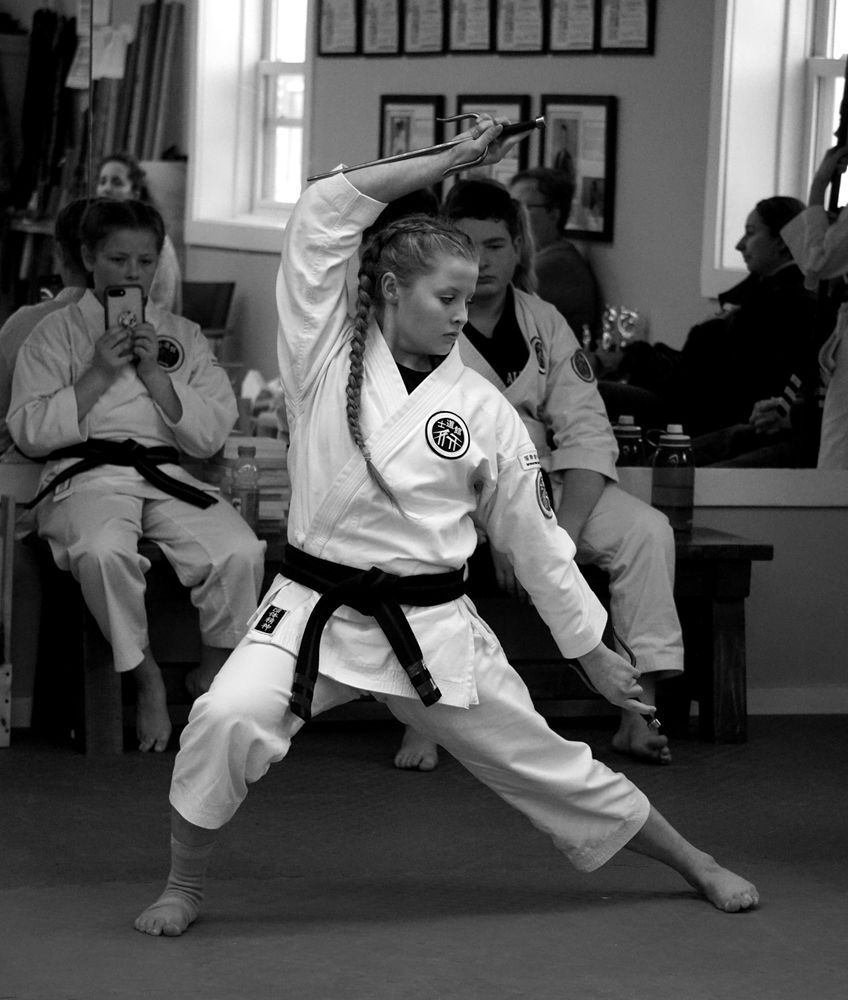 Alpha Martial Arts Academy student training with weapons